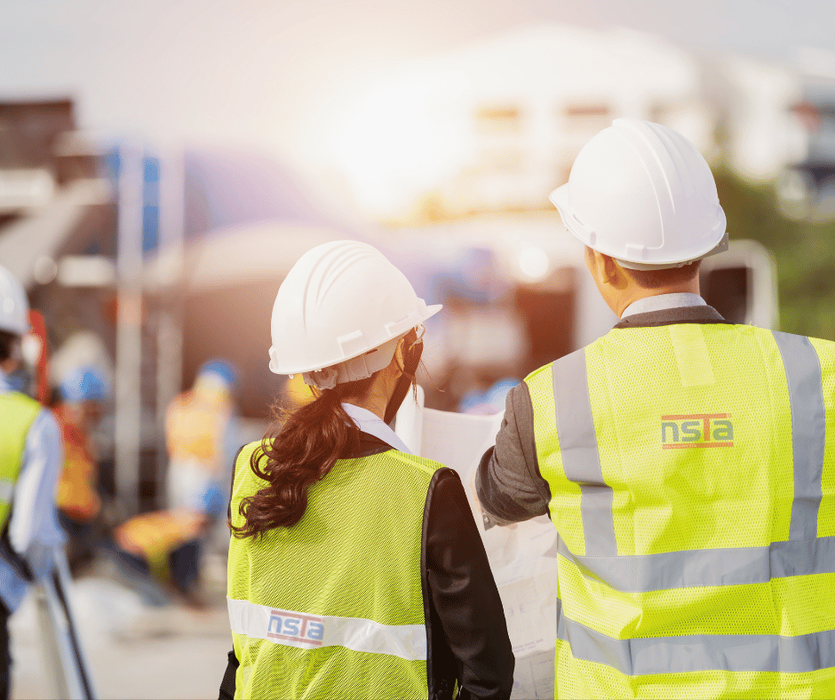 Construction worker in high-visibility vest giving thumbs up at worksite, promoting White Card NSW course